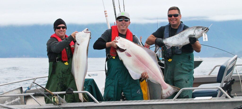 Catching halibut and Silver or Coho Salmon in a fishing boat on a fishing vacation in BC Canada