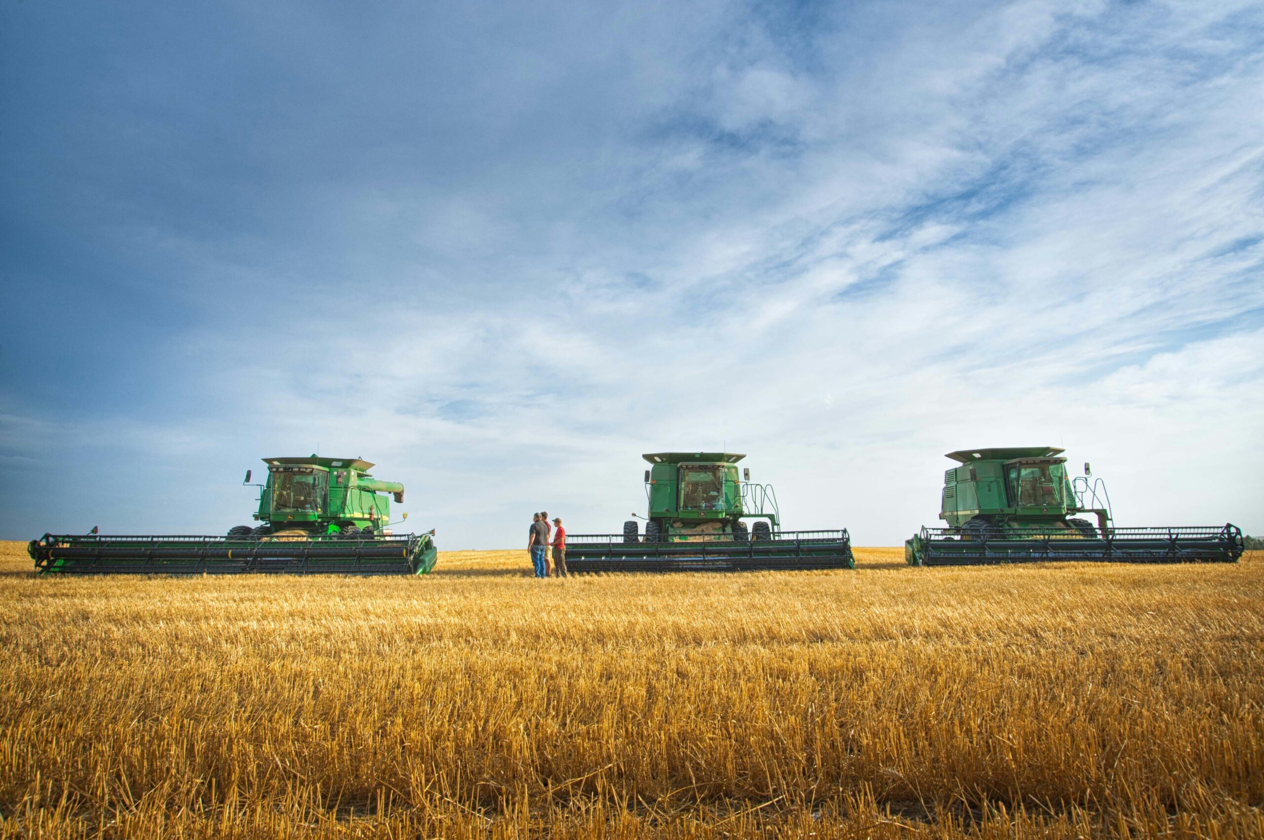 combines in a field, North Dakota. Photo by Darla Hueska