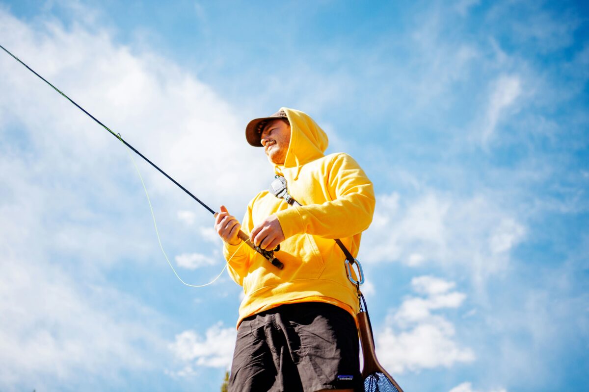 Man fishing in yellow rain coat. Photo by Taylor Kidd